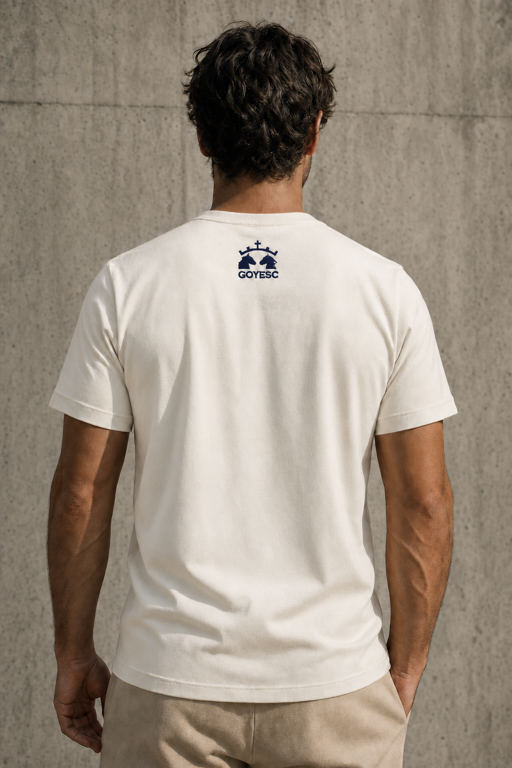 Espalda de la camiseta GOYESC en color blanco roto, con logo dorado en la nuca
